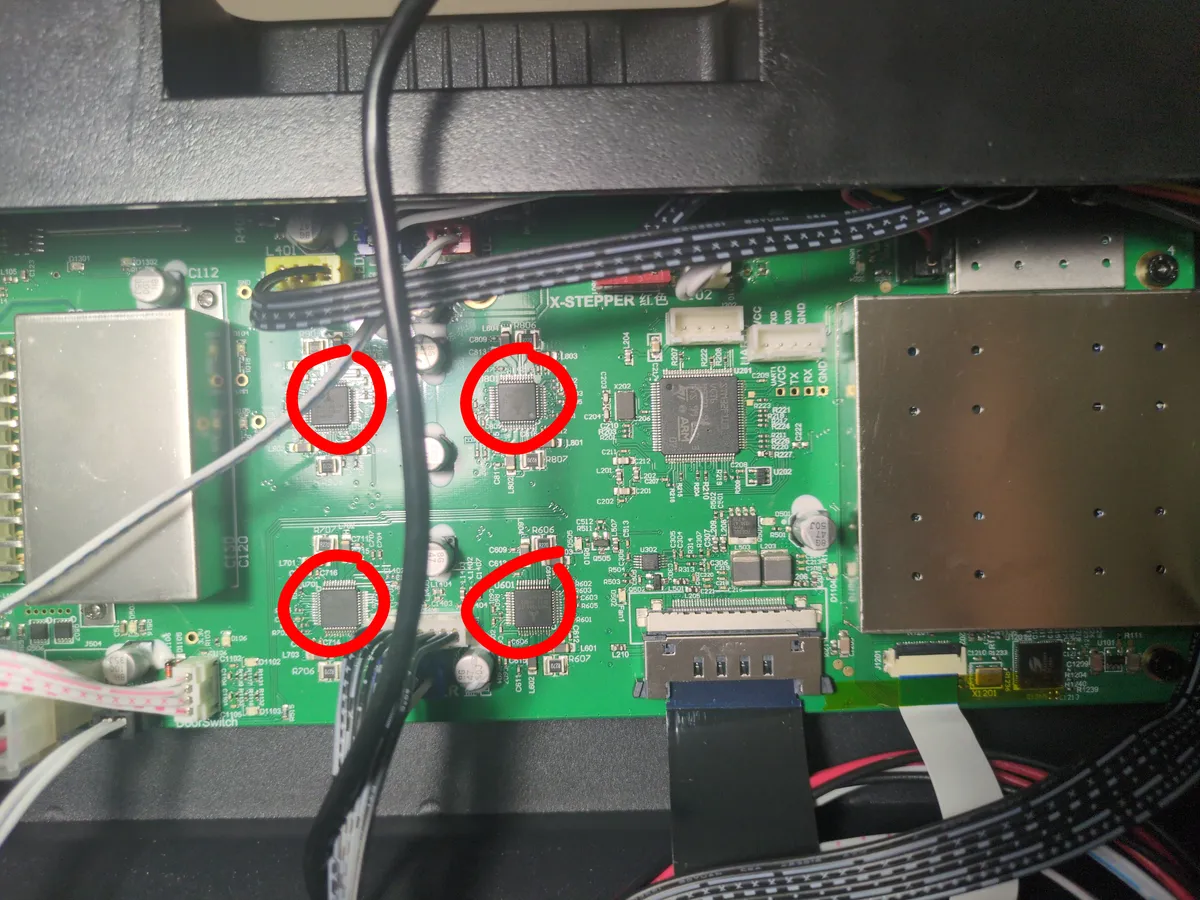 Motherboard still installed in the printer with controller ICs circled